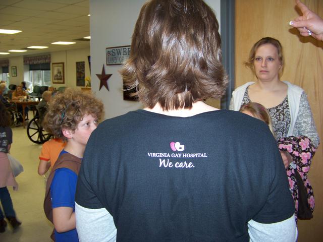 Article Thumbnail. WE CARE. Birker, Nurse Mgr, wears her commitment to Nursing & Rehab on her shirt.