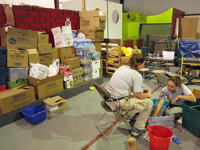 Article Thumbnail. Hannah Moore, and Lanice Bailey, sort hygiene products to be given to tornado survivors